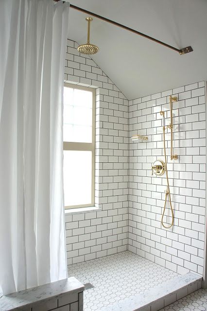 Subway tile and brass shower.